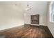 An airy living room showcasing a modern electric fireplace, hardwood floors, and a vaulted ceiling at 1397 Thomas Rd, Decatur, GA 30030