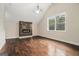 A spacious living room featuring a vaulted ceiling, a modern fireplace, and a large window at 1397 Thomas Rd, Decatur, GA 30030