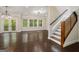 Spacious living room with hardwood floors, staircase, and multiple windows for natural light at 1397 Thomas Rd, Decatur, GA 30030