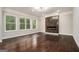 Bright living room featuring a linear fireplace, hardwood floors, and three large windows at 1397 Thomas Rd, Decatur, GA 30030