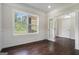 Bright living room featuring hardwood floors, a large window, and white trim at 1397 Thomas Rd, Decatur, GA 30030