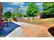 This backyard has a large concrete patio, a red swing set, and a grill, perfect for outdoor entertaining at 5845 Princeton Run Trl, Tucker, GA 30084