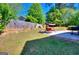 The backyard features a swing, large grassy area, and is surrounded by lush trees and a wooden fence at 5845 Princeton Run Trl, Tucker, GA 30084