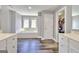 Bright bathroom with dual windows over a soaking tub, dual sinks, and dark hardwood floors at 5845 Princeton Run Trl, Tucker, GA 30084