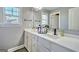Bright bathroom featuring double sinks, white cabinets and countertops, and modern fixtures at 5845 Princeton Run Trl, Tucker, GA 30084