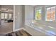 Bright bathroom with dual windows over a soaking tub and dark hardwood floors at 5845 Princeton Run Trl, Tucker, GA 30084
