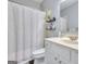 Clean bathroom featuring a white vanity, toilet, and shower with a light gray shower curtain at 5845 Princeton Run Trl, Tucker, GA 30084