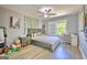 This bedroom features a ceiling fan, gray walls, a cozy bed, and natural light from the window at 5845 Princeton Run Trl, Tucker, GA 30084
