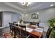 Bright dining room featuring a large table, stylish decor, and laminate floors at 5845 Princeton Run Trl, Tucker, GA 30084