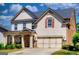 Charming two-story home featuring a stone-accented entrance, attached garage, and well-maintained landscaping at 5845 Princeton Run Trl, Tucker, GA 30084