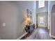 Bright foyer with a high ceiling, dark laminate flooring, and stylish console table at 5845 Princeton Run Trl, Tucker, GA 30084
