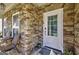 Inviting front porch featuring stone accents, a cozy seating area, and a welcoming entrance at 5845 Princeton Run Trl, Tucker, GA 30084