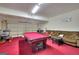 Spacious game room featuring a pool table, comfortable sofa, and finished garage door at 5845 Princeton Run Trl, Tucker, GA 30084