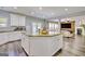 Modern kitchen with a large island with seating and an open view to the living room at 5845 Princeton Run Trl, Tucker, GA 30084