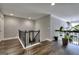 Bright upstairs landing area with wood flooring and wrought iron banister overlooking the main floor at 5845 Princeton Run Trl, Tucker, GA 30084
