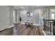 Hallway featuring wood flooring, neutral paint, a round mirror, and a bench at 5845 Princeton Run Trl, Tucker, GA 30084