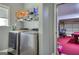 Functional laundry room featuring appliances and an open entryway at 5845 Princeton Run Trl, Tucker, GA 30084