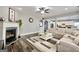 Open living room with fireplace, ceiling fan, and view into the bright, white kitchen at 5845 Princeton Run Trl, Tucker, GA 30084