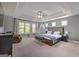 The main bedroom is spacious with tray ceilings, natural light, and a seating area for relaxation at 5845 Princeton Run Trl, Tucker, GA 30084
