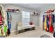 Spacious walk-in closet with ample storage, shelving, seating and organized hanging space at 5845 Princeton Run Trl, Tucker, GA 30084