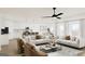 Bright and open-concept living room featuring contemporary decor and seamless flow to the kitchen and dining area at 782 Grande Bishop Dr, Fairburn, GA 30213