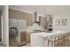 Modern kitchen with stainless steel appliances, stone countertops, and a center island with seating at 787 Grande Bishop Dr, Fairburn, GA 30213