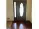 Elegant front door with decorative glass insert and gleaming hardwood floors at 128 Kelleytown Woods Dr, Mcdonough, GA 30252