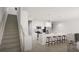 Modern kitchen with stainless appliances, island seating, and stairs nearby at 2278 Santa Fe St, Morrow, GA 30260