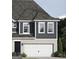 Charming home exterior featuring a two-car garage and vertical siding details at 2280 Santa Fe St, Morrow, GA 30260