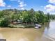 Stunning aerial shot of a lake house with private dock surrounded by lush greenery and calm waters at 2000 Campbell Rd, Covington, GA 30014