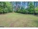 Large, grassy backyard surrounded by mature trees at 2000 Campbell Rd, Covington, GA 30014