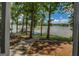 Landscaped backyard view of a tranquil lake and private dock at 2000 Campbell Rd, Covington, GA 30014