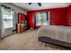Bright bedroom with red accent wall, dresser and window, offering a cozy and stylish retreat at 2000 Campbell Rd, Covington, GA 30014