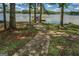 Inviting brick path leading to a private dock with covered boat slip on a serene lake setting at 2000 Campbell Rd, Covington, GA 30014
