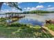 Lake house view with a covered dock and boat slip, surrounded by lush greenery and serene waters at 2000 Campbell Rd, Covington, GA 30014