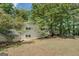 Lakeside home surrounded by lush trees, showcasing serene views and a peaceful setting at 2000 Campbell Rd, Covington, GA 30014