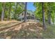 Two-story home with green shutters and a porch, set in a tranquil wooded area at 2000 Campbell Rd, Covington, GA 30014