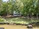 Scenic view of a lakeside house nestled among lush trees offering privacy and tranquility at 2000 Campbell Rd, Covington, GA 30014