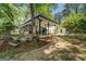 Charming lakeside home featuring a screened porch, covered patio, and lush landscaping at 2000 Campbell Rd, Covington, GA 30014