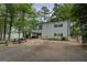 Charming two-story home with green shutters and a covered patio for outdoor dining near the tranquil lake at 2000 Campbell Rd, Covington, GA 30014