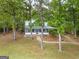 Beautiful two-story home with a lush green lawn surrounded by mature trees at 2000 Campbell Rd, Covington, GA 30014