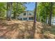 Charming two-story home nestled among mature trees on a lakeside property at 2000 Campbell Rd, Covington, GA 30014