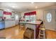 Eat-in kitchen with wood floors, island, and white cabinetry at 2000 Campbell Rd, Covington, GA 30014