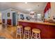 Well-lit kitchen with wood floors, red accents, and a breakfast bar at 2000 Campbell Rd, Covington, GA 30014