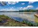 Scenic lake view showcasing the calm waters, lush shoreline, and a partially-obscured dock on the right at 2000 Campbell Rd, Covington, GA 30014