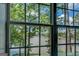 Lake view featuring large windows overlooking the calm waters, lush greenery, and serene landscape at 2000 Campbell Rd, Covington, GA 30014