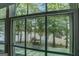 Lake view featuring large windows overlooking water, dock, trees, and nature at 2000 Campbell Rd, Covington, GA 30014
