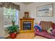 Cozy living area with a fireplace, large window with natural light, and comfortable seating at 2000 Campbell Rd, Covington, GA 30014