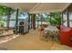 Covered patio with grill and seating area, overlooking a serene lake at 2000 Campbell Rd, Covington, GA 30014