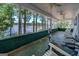 Serene screened-in porch featuring ceiling fans, comfortable seating, and breathtaking lake views at 2000 Campbell Rd, Covington, GA 30014